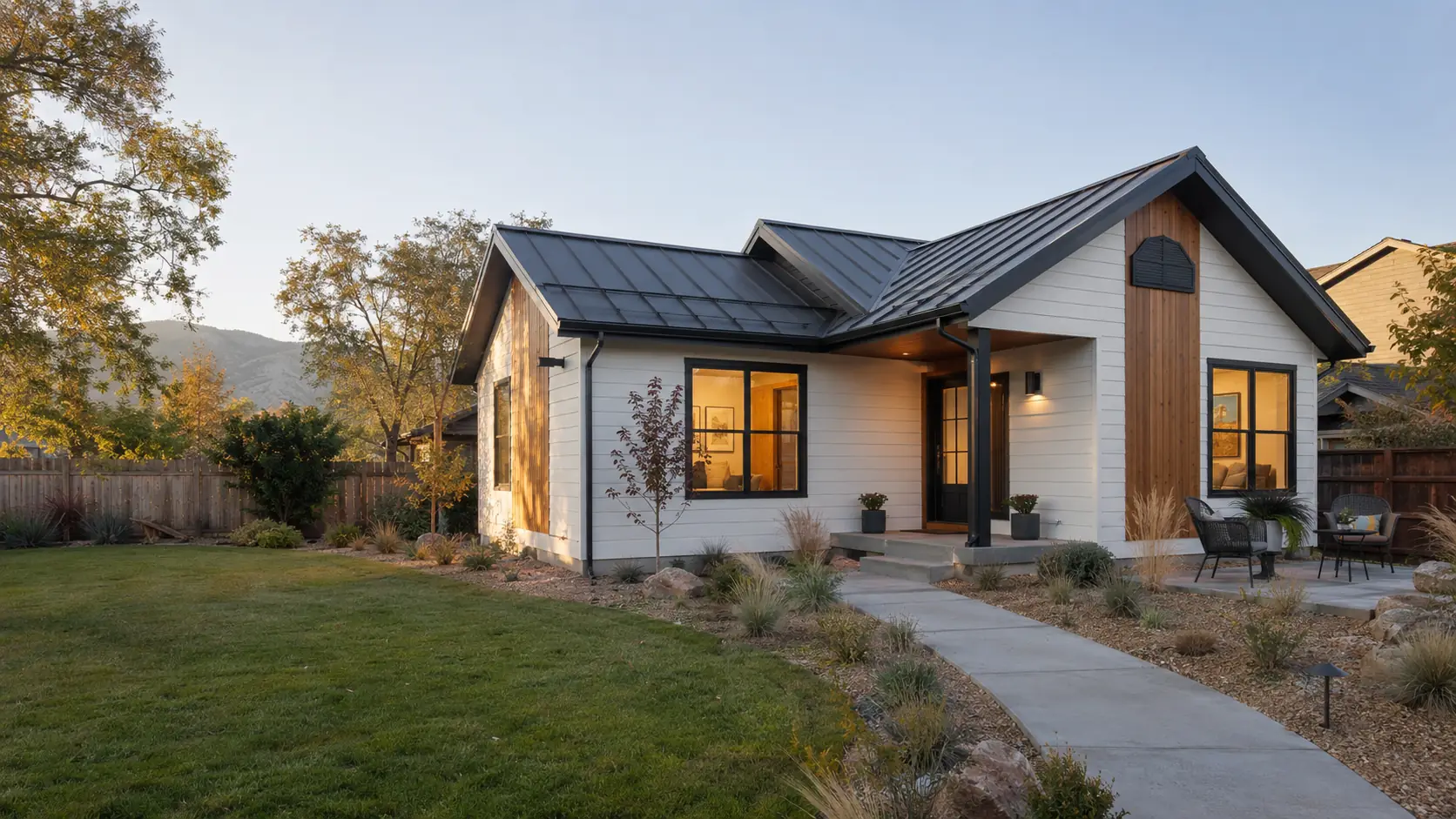 Detached accessory dwelling unit in the Treasure Valley, with board-and-batten siding, a standing-seam metal roof, cedar accents, and a covered entry at golden hour